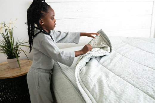 
      Young girl zips up her zipper Beddys bedding.
    