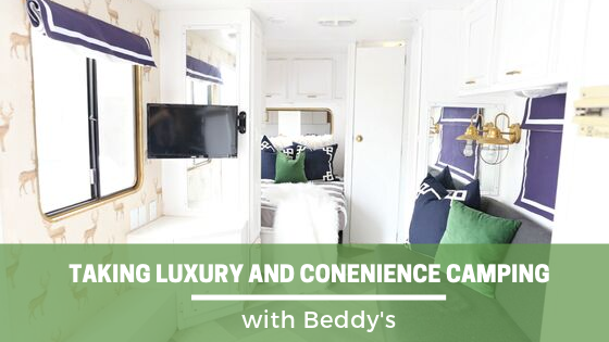 
      The inside of an RV, a bed made with zipper bedding visible
    