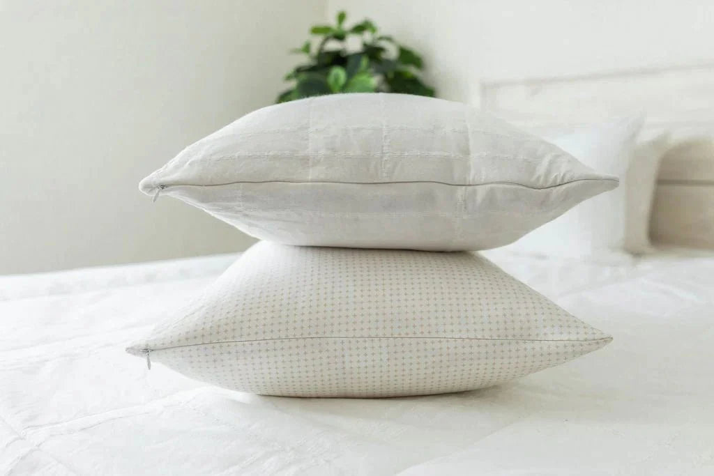 
      A side view of a bed made with zipper bedding with two pillows stacked on top.
    