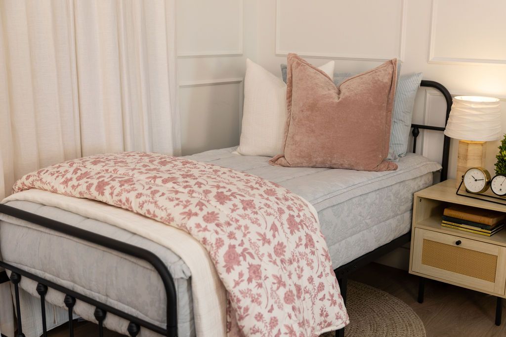Light blue floral embossed zipper bedding with cream tan and terracotta accessories