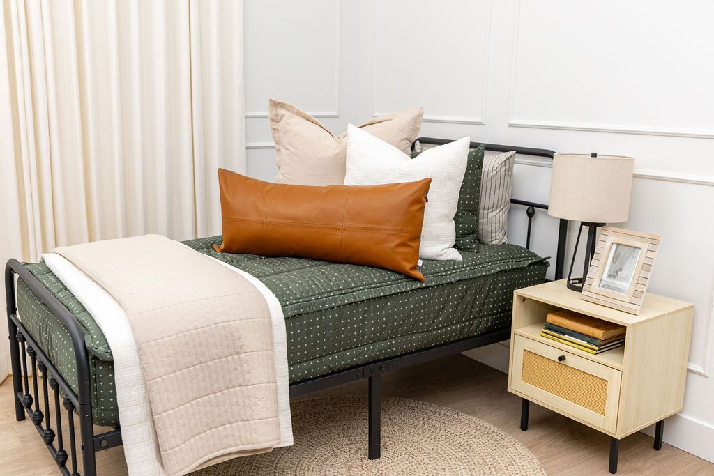 Green zipper bedding with white cream and tan accessories