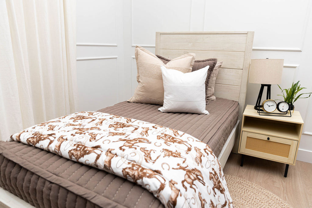 Brown stitched zipper bedding with neutral and sage green bedding accessories