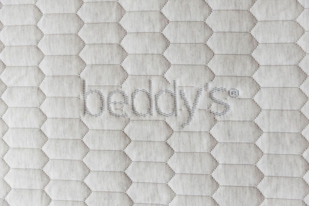 A close up of the Beddys logo on a zipper mattress,