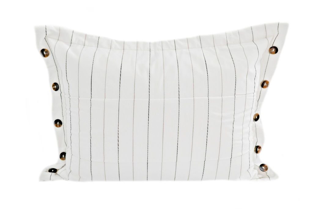 A white sham pillow with a vertical pin stripe design and brown buttons.
